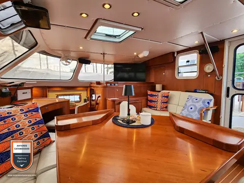 Cloud Nine Antares listing photo showing salon table aft view.