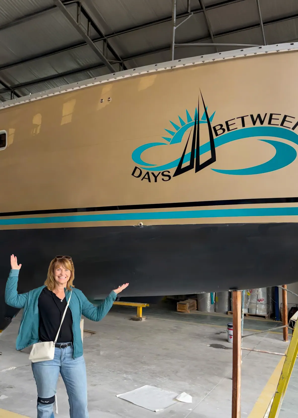 New Antares owner at the factory beneath a finished catamaran hull