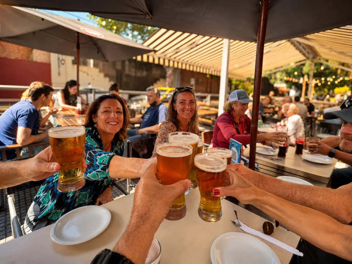 Owners raising glasses at a casual Antares community dinner
