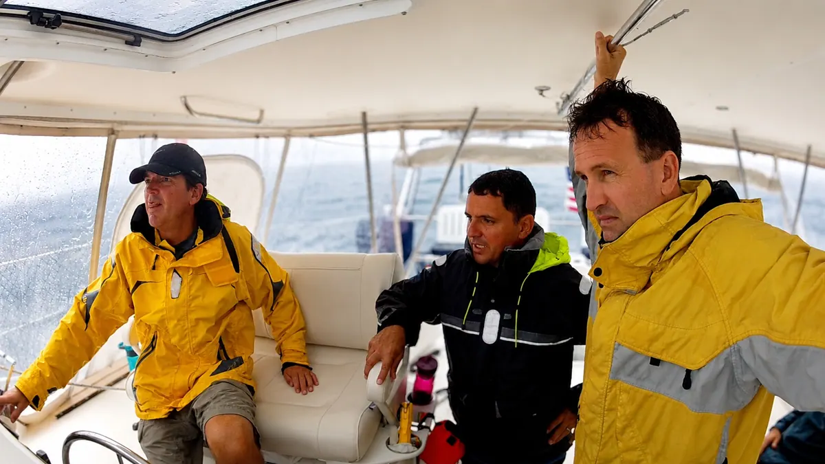 Crew gathered at the helm during passage life aboard an Antares catamaran