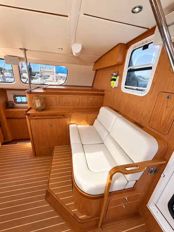 Lucy Antares listing photo showing forward settee chart storage.