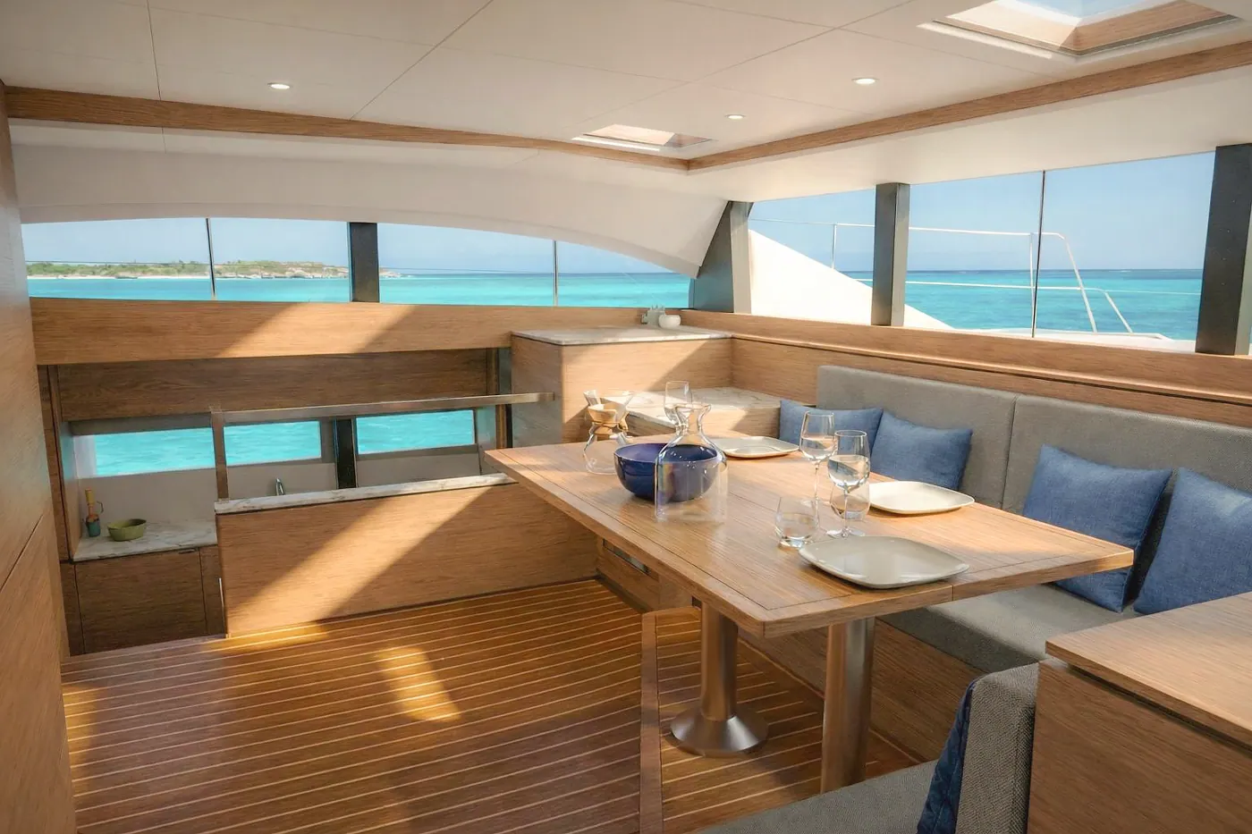 Antares 46 galley-down saloon with dining table and ocean views
