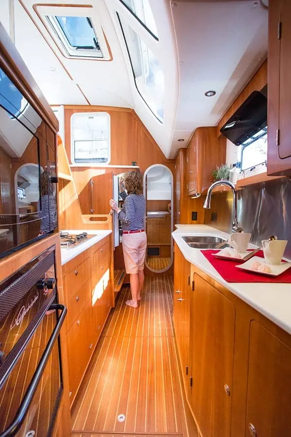 Antares 44 GS galley refrigerator and storage along the companionway