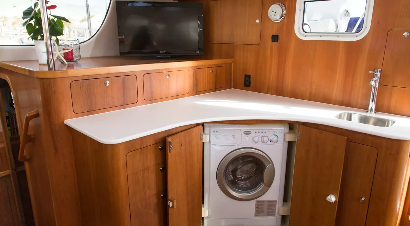Antares 44 GS washer-dryer integrated into saloon cabinetry