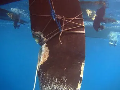 Damaged rudder and skeg after underwater impact on a cruising catamaran