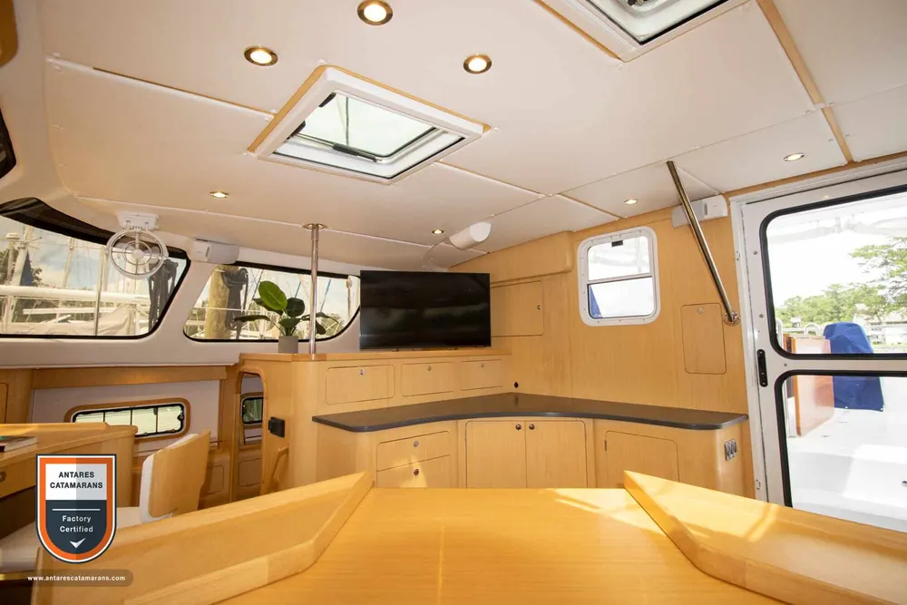 Zephyr Antares listing photo showing salon table looking aft.