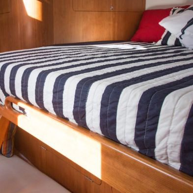 Optional forward guest cabin layout includes a single bunk below with a double bed accessed by an integrated ladder